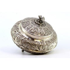 Silver box with plant motifs, dove finial, and three feet