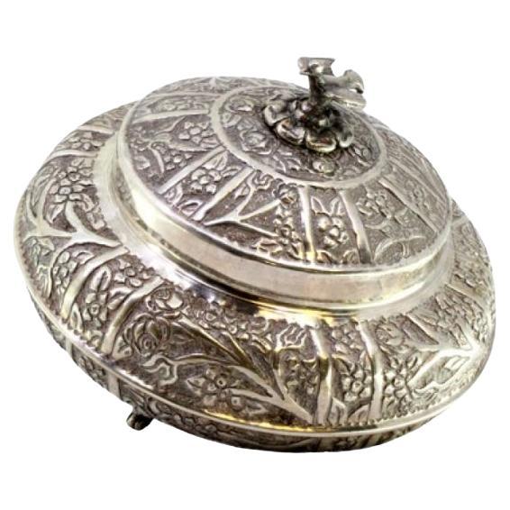 Silver box with plant motifs, dove finial, and three feet