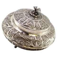 Silver box with plant motifs, dove finial, and three feet