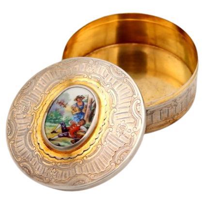 Silver box with reliefs and enameled monogram with idyllic scene