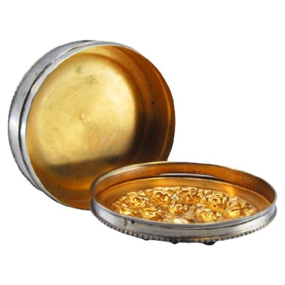 Silver box with rose-shaped relief on the lid and rim