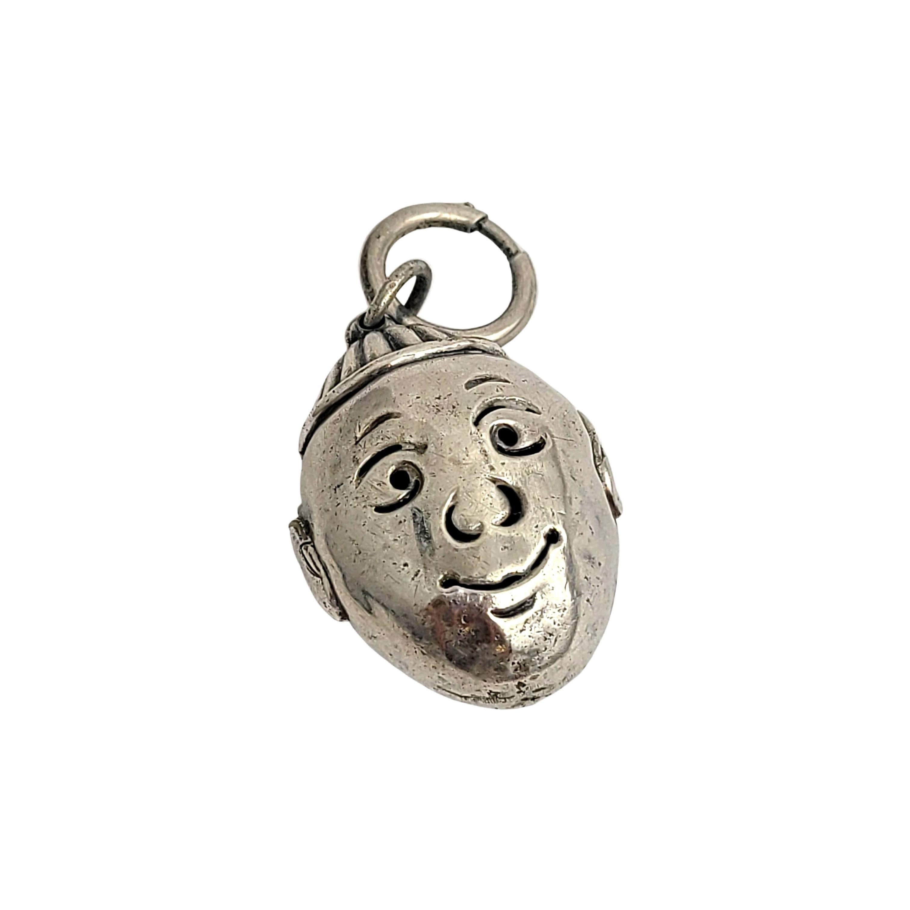 Silver rattle/bell  boy charm.

This is a charming silver little boy's face charm rattle or bell. It has a soft sweet jingle when you shake it. Large clasp to attach the charm.

Measures approx 1 5/8