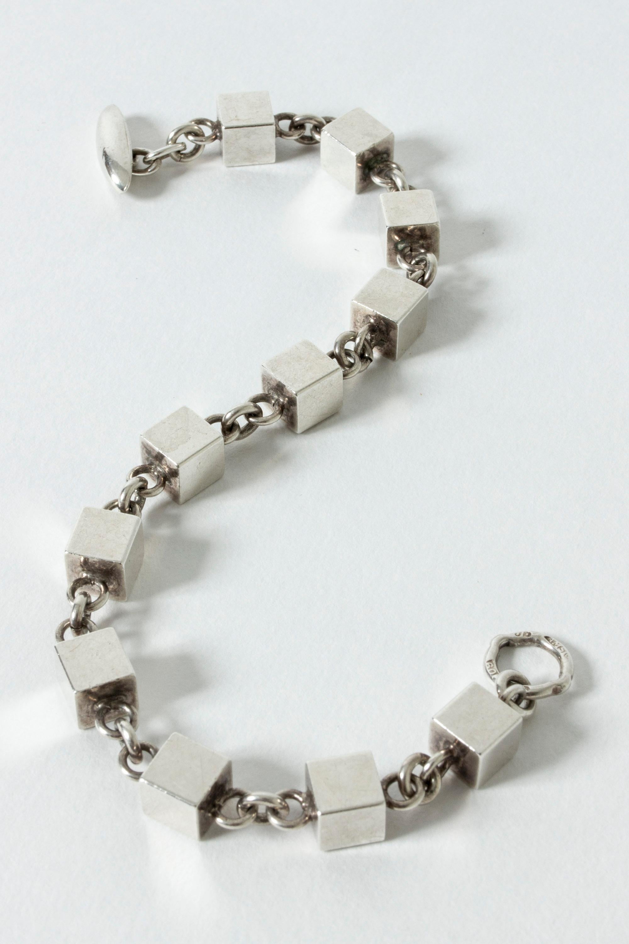Very elegant silver bracelet by Arvo Saarela, made from numerous interlocking cubes. Solid cubes, weighty quality. Nice contrast with the neat chains.