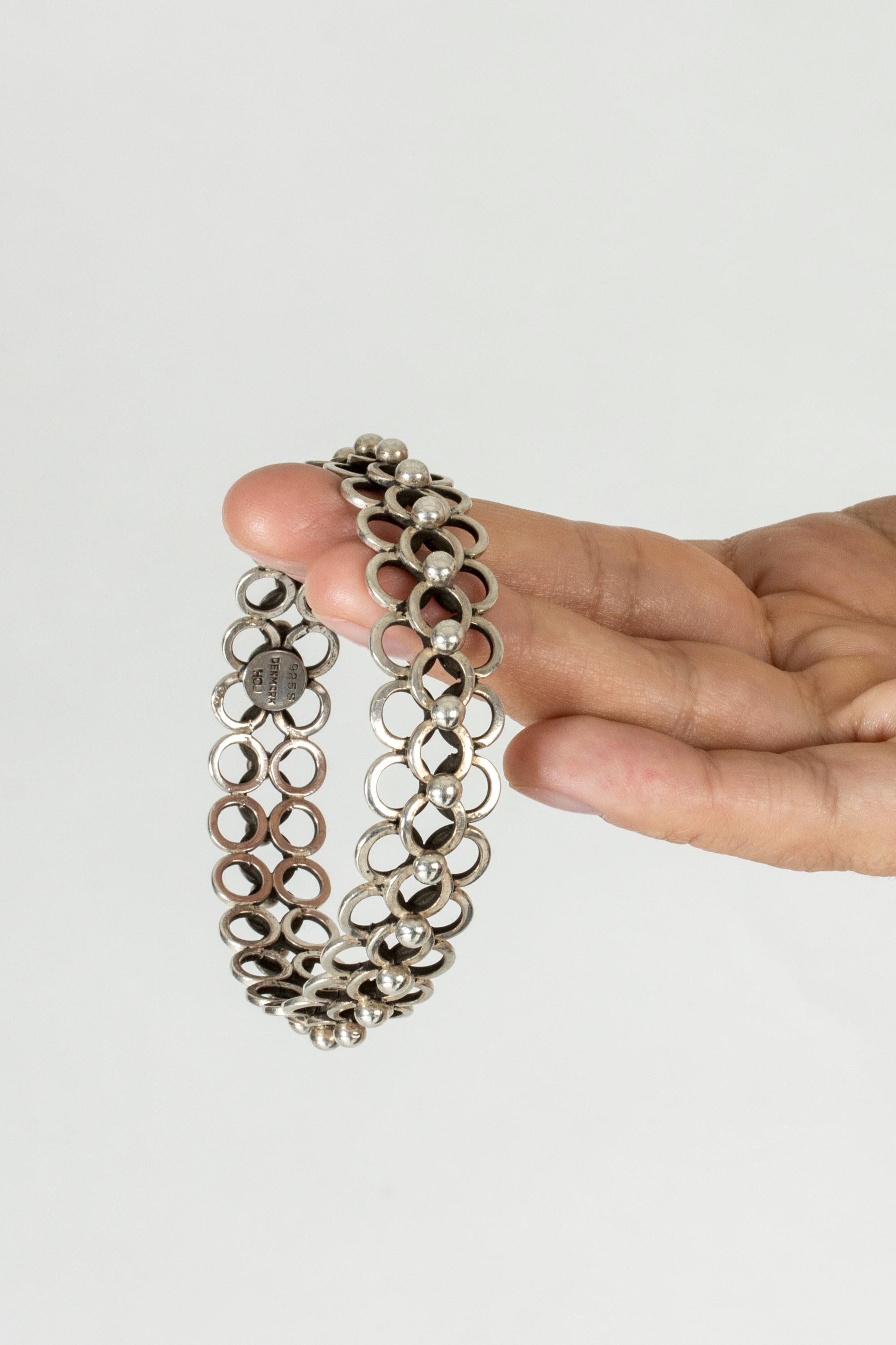 Very elegant silver bracelet by Hermann Ole Jacobsen, in an intricate design of interlocking silver hoops.

