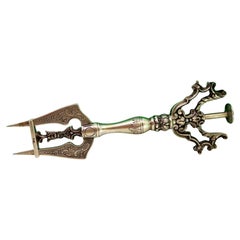 Silver bread fork with two engraved tines and floral appliqué handle