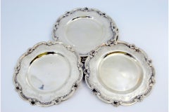 Silver bread plates with engravings and shells