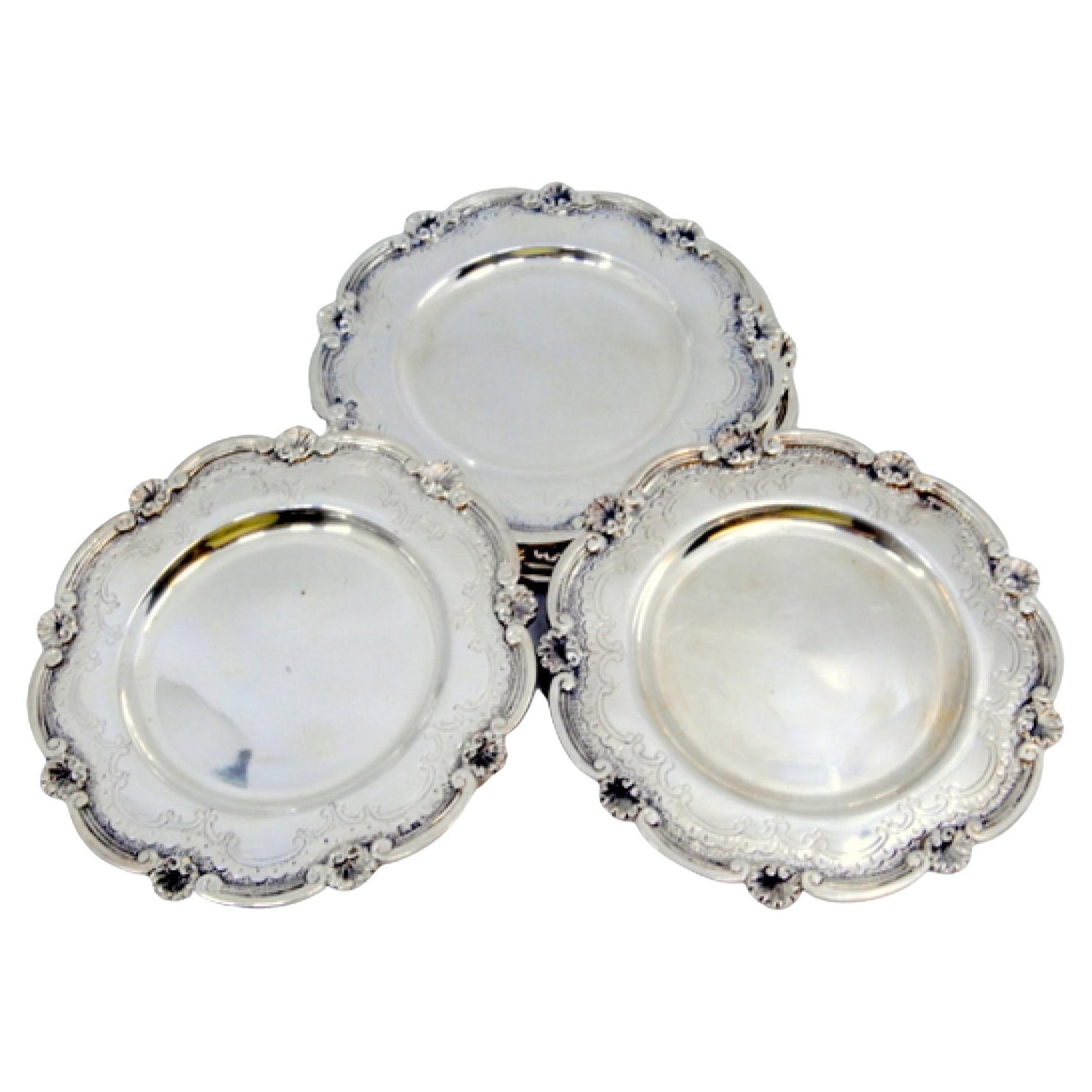 Silver bread plates with engravings and shells