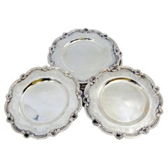 Silver bread plates with engravings and shells