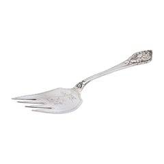 Silver bread serving fork with reliefs on the handle and engraved floral motifs
