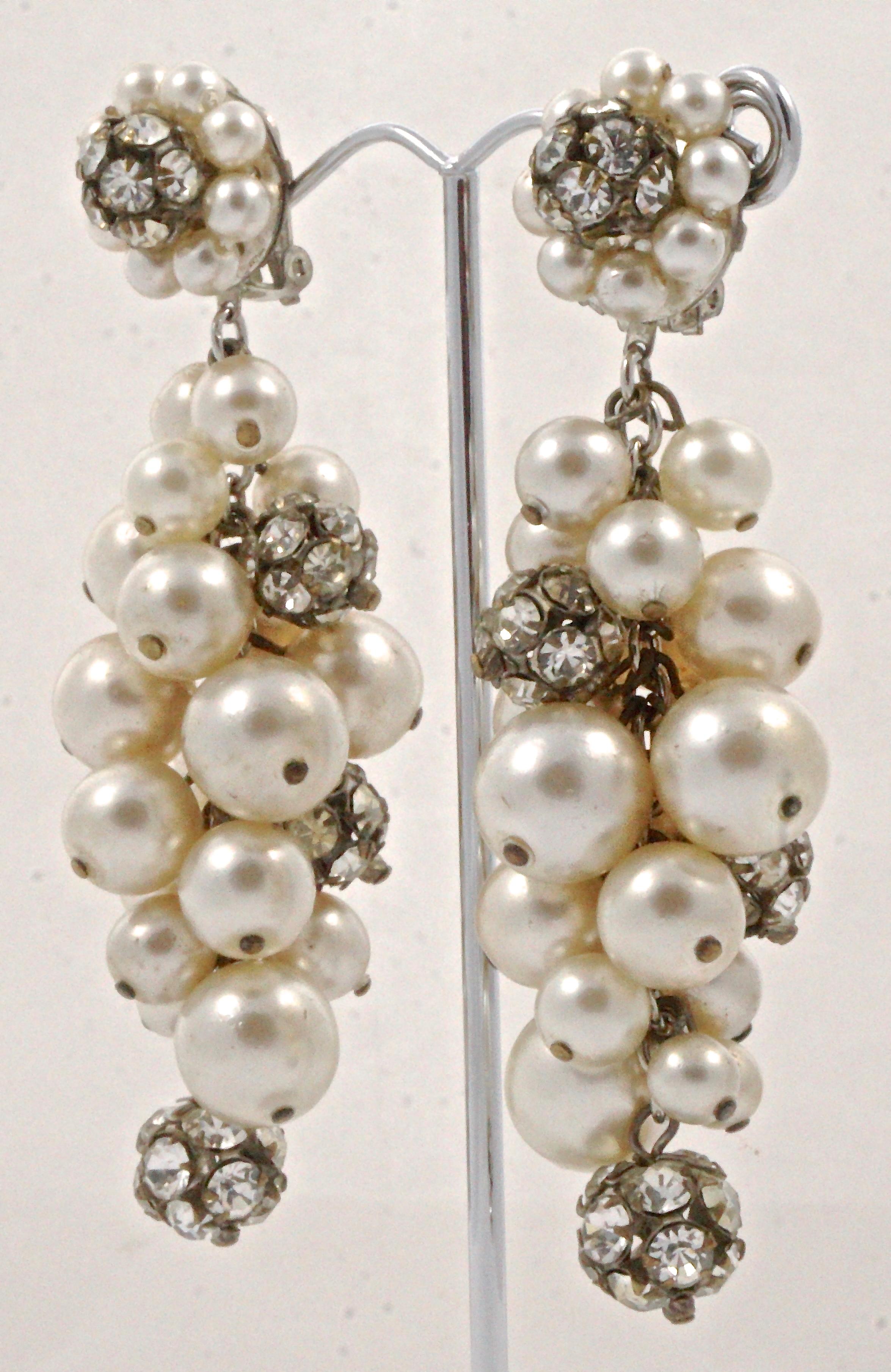 Glamorous vintage silver tone and bronze tone clip on drop earrings, featuring clusters of cream faux pearls and rhinestone balls. Measuring length 8.5cm / 3.34 inches, circa 1960s. The clips work well, there is wear to the silver plating, and some
