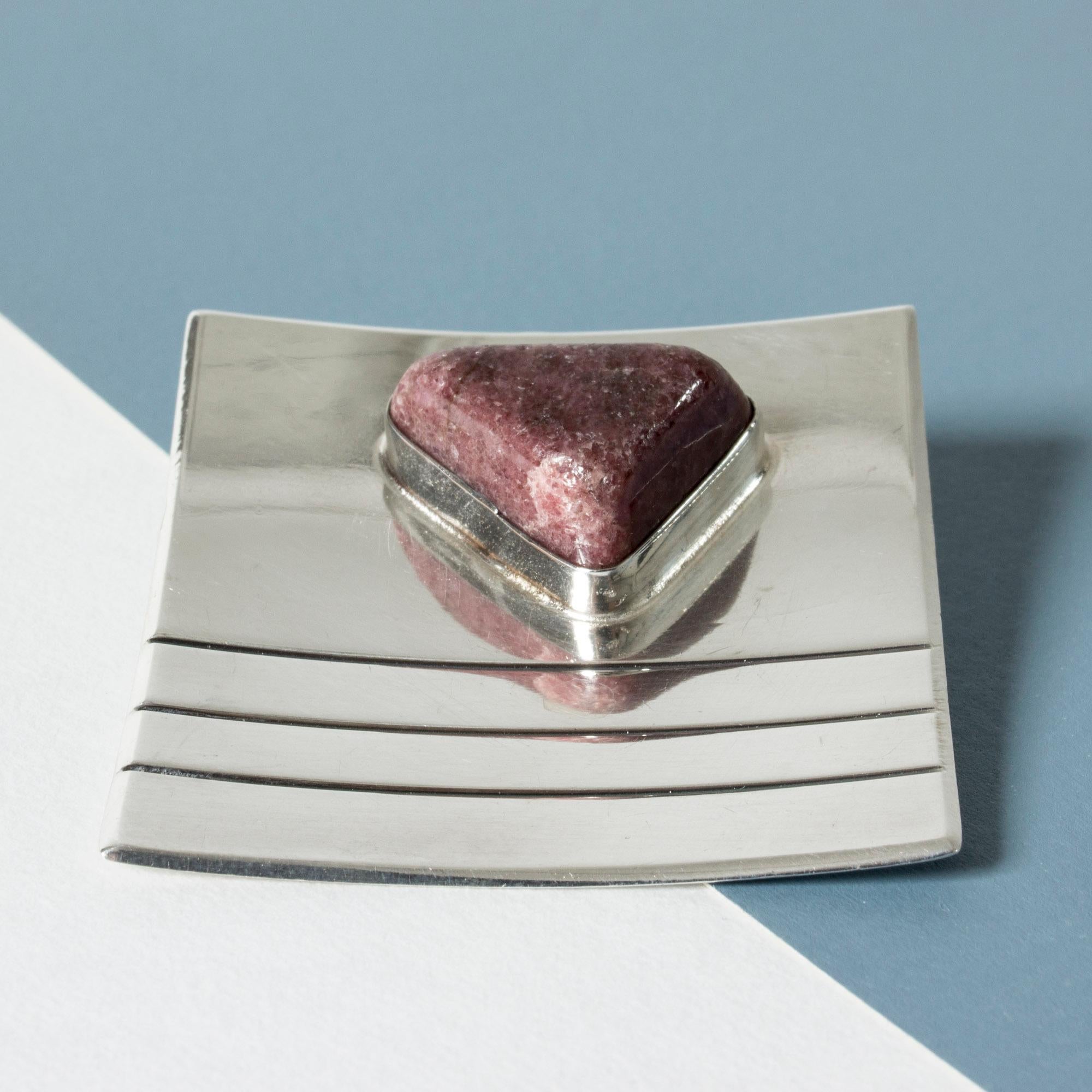Striking, large brooch by Heikki Kaksonen, made from silver in a square form with embossed stripes. Red aventurine stone in an organic form, makes a beautiful contrast.