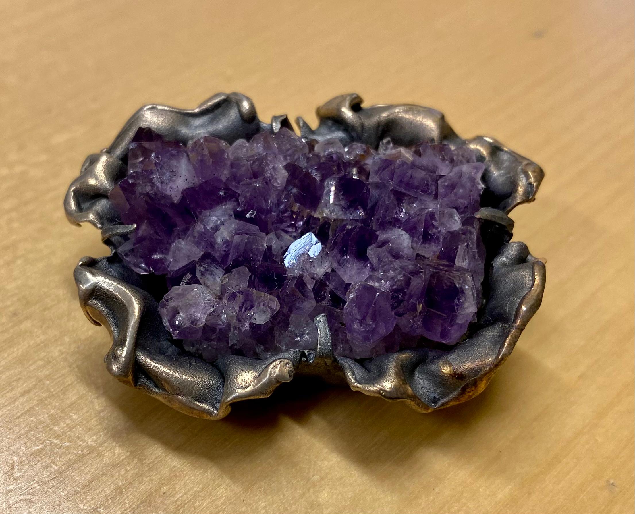 A silver brooch designed by Reino Saastamoinen.

Age: Vintage

From: 1972

Material: Silver

Sterling Silver 925

Stone: Amethyst

Designer: Reino Saastamoinen