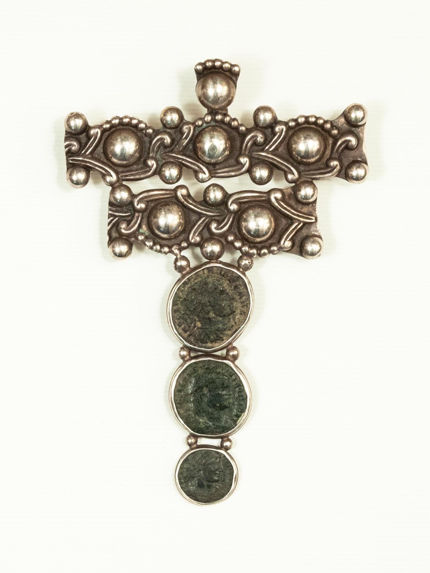 Large and unique silver brooch with three antique bezel-set coins. The verso is set with a pin to wear as a brooch, and also a bale to string on leather or chain to wear as a pendant necklace.
Marked Rancho Alegre STERLING MADE IN TAXCO. Plateria