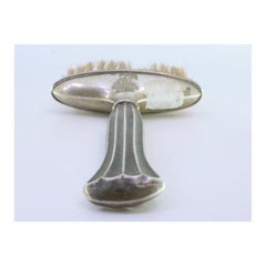 Silver broom with reliefs and fluted handle