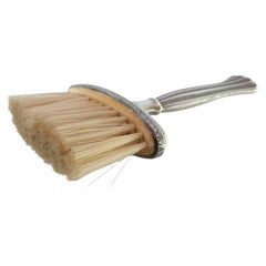 Silver broom with reliefs and fluted handle