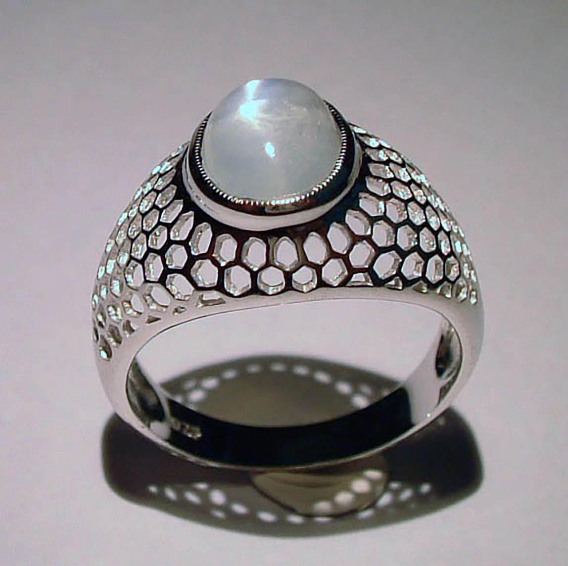 This Unique Silver Ring is set with a Large 5.6 Carat Burmese Moonstone. The Geometric Design is Timeless and is a Size 8.5 USA

Originally from San Diego, California, Kary Adam lived in the “Gem Capital of the World” - Bangkok, Thailand, sourcing