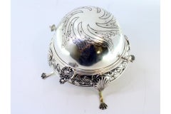 Silver butter dish with engravings and reliefs on the surround, hinged lid