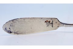 Silver butter knife with dog figure