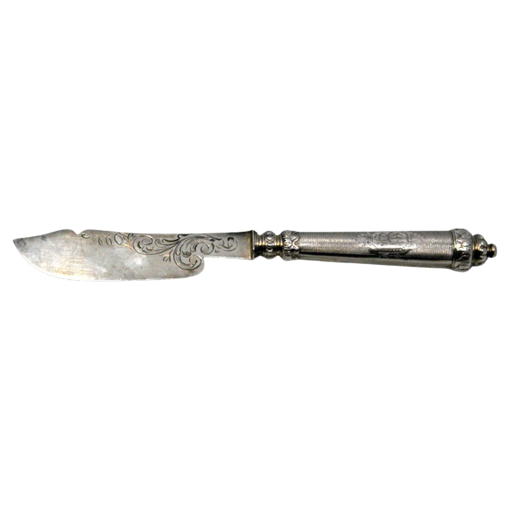 Silver butter knife with engraving on the blade and perforation on the handle