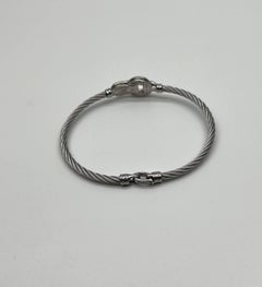 Bracciale a cavi in argento con diamanti in oro bianco a 18 carati, con simbolo di dichiarazione in filigrana