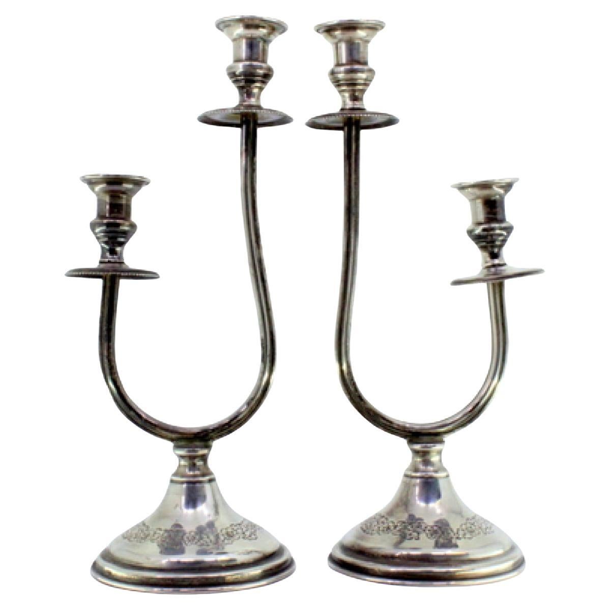 Silver candelabra w/ two beaded lights
floral reliefs on the circular bases