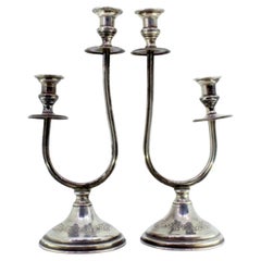 Silver candelabra w/ two beaded lights 
floral reliefs on the circular bases