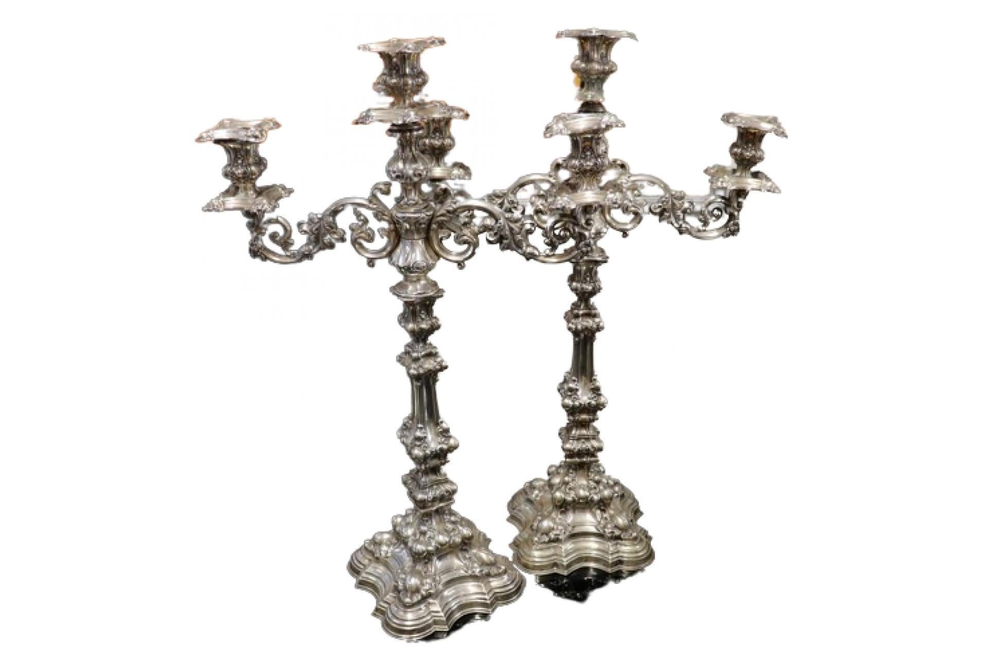 Description: Silver candelabra with reliefs and applications set on gradient frieze bases. Metal: Silver. Origin: Portuguese. Brand: Porto Coroa. Weight: 3,252.02 grams. Dimensions: 39.5cm x 61cm. Content: 833/1000. Assay Mark: Yes, from the 15th
