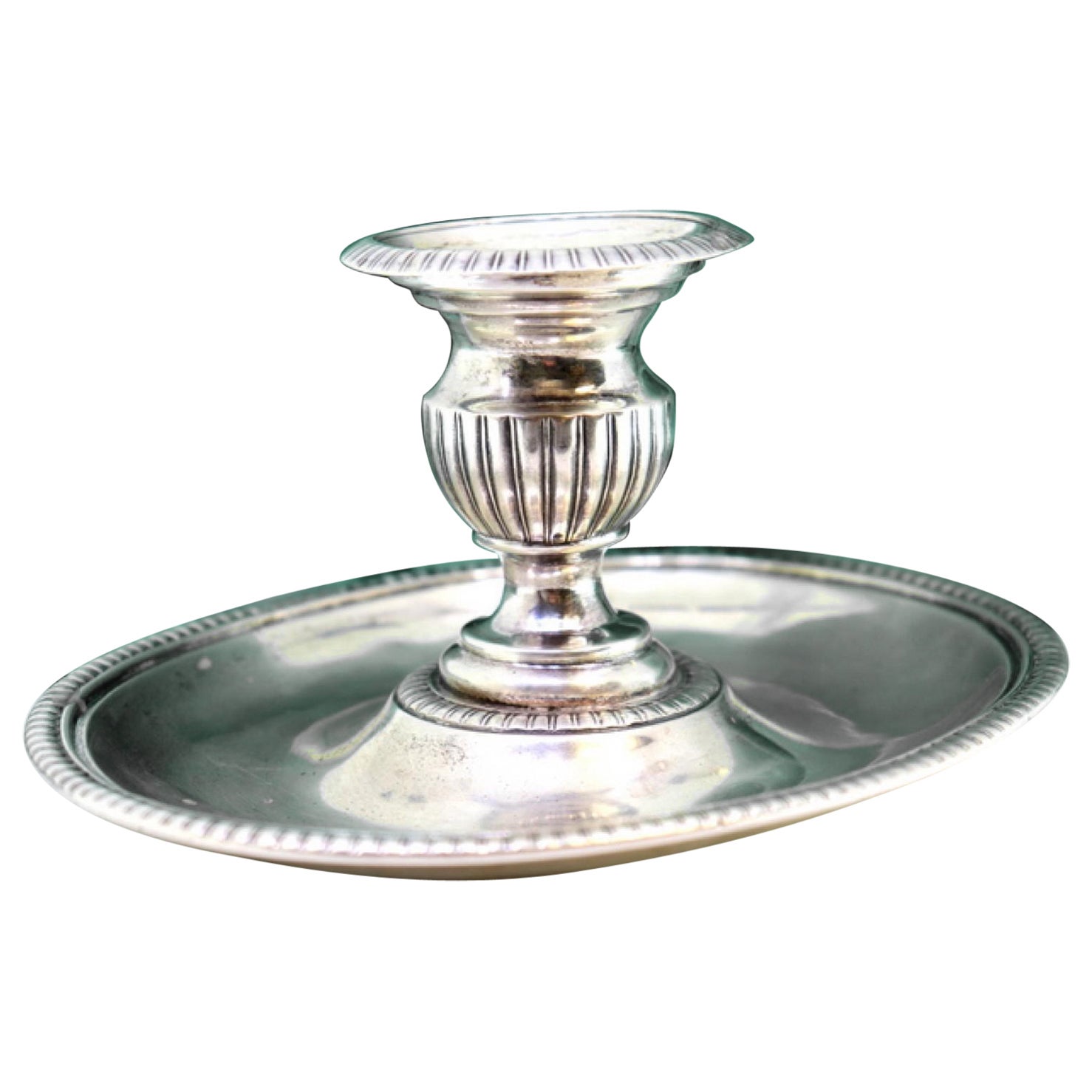 Silver candlestick with elliptical embossed and pearled reliefs
