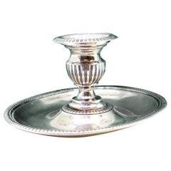 Silver candlestick with elliptical embossed and pearled reliefs