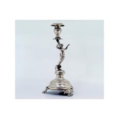 Silver candlestick with flower held by female figure on cut-out base