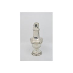 Silver candlestick with friezes around the edges and set on a circular base