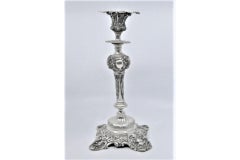 Silver candlesticks embossed w/ floral motifs & scrolls, sconces & cut-out bases
