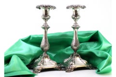 Silver candlesticks with acanthus-embossed shafts on square bases