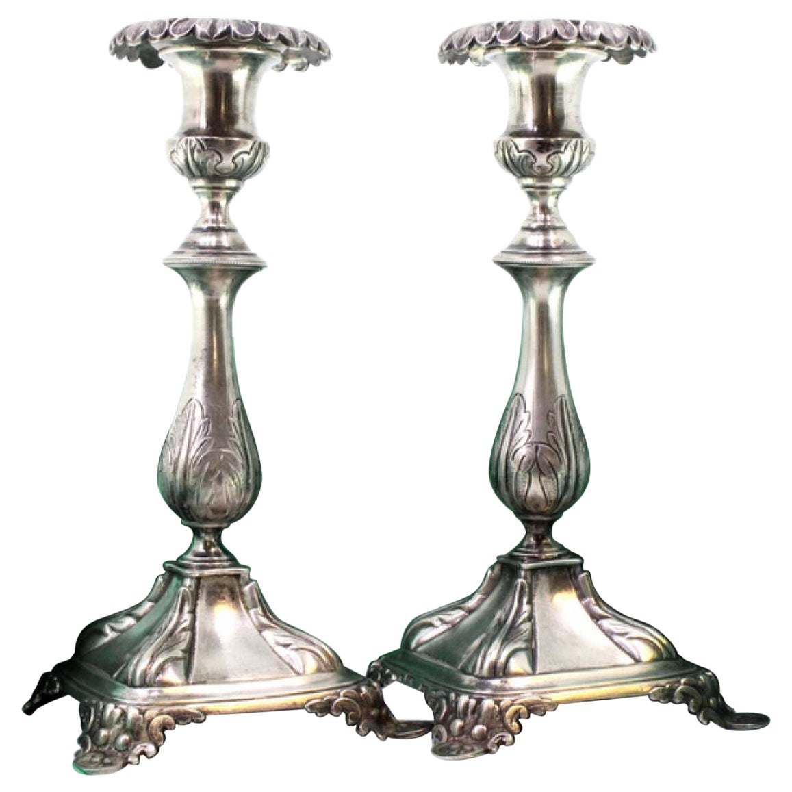 Silver candlesticks with acanthus-embossed shafts on square bases