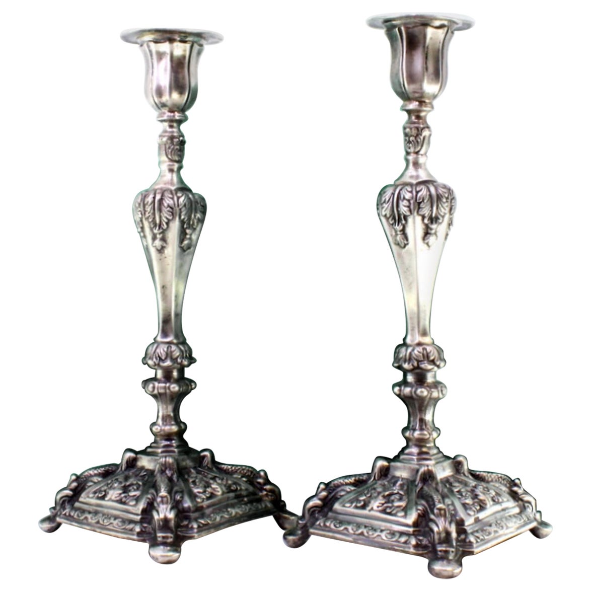 Silver candlesticks with acanthus leaves and mythical figures on square bases