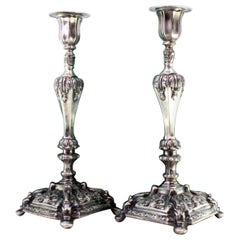 Silver candlesticks with acanthus leaves and mythical figures on square bases