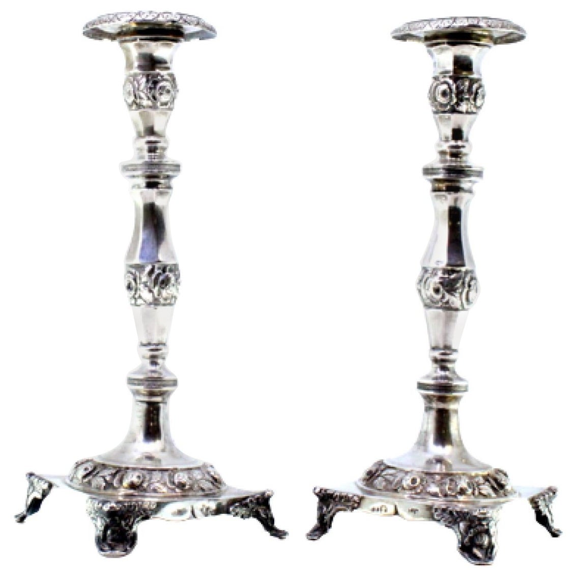 Silver candlesticks with embossed florals on square bases with four raised feet