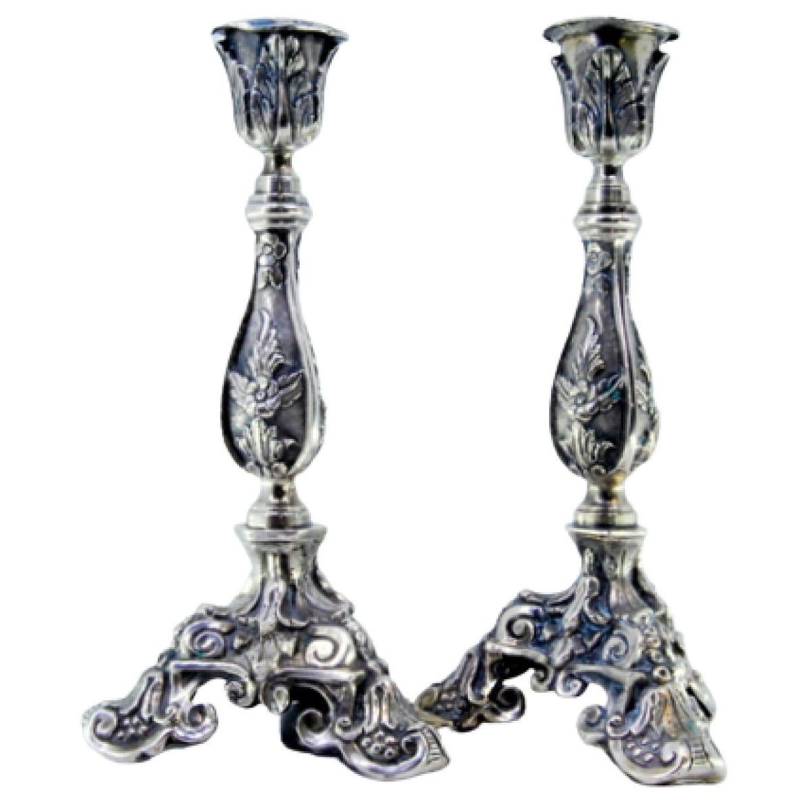 Silver candlesticks with embossed flowers and acanthus leaves on three feet
