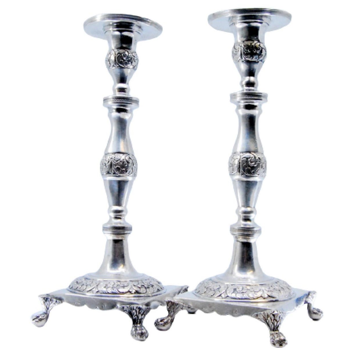 Silver candlesticks with engraved floral stems on four-footed square bases