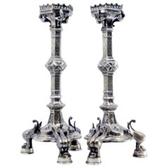 Silver candlesticks with grated stems on hexagonal bases over swans Silver candlesticks with grated stems on hexagonal bases over swans