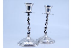 Silver candlesticks with rubberized circular bases and applied sconces