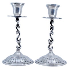 Silver candlesticks with rubberized circular bases and applied sconces