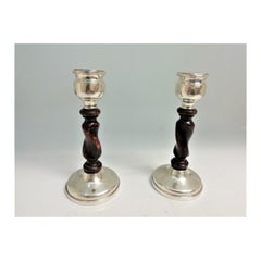 Silver candlesticks with spiral wooden shafts and placed on circular bases