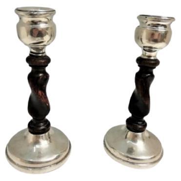 Silver candlesticks with spiral wooden shafts and placed on circular bases For Sale