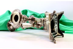 Silver candlesticks with turned shafts on square bases with claw feet