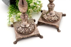 Silver candlesticks with turned shafts on square bases with claw feet