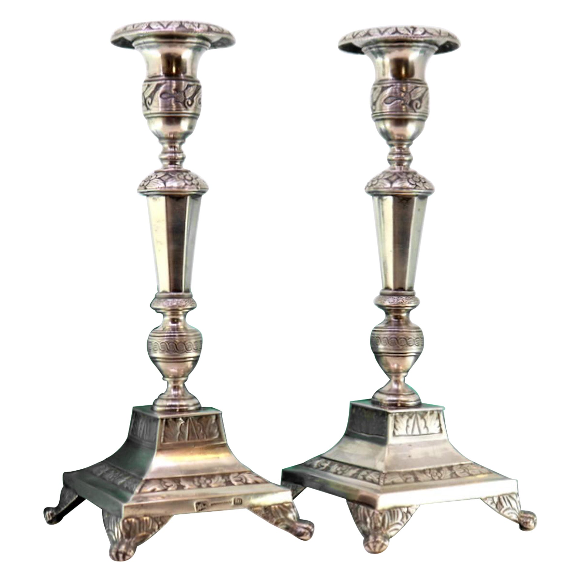 Silver candlesticks with turned shafts on square bases with claw feet
