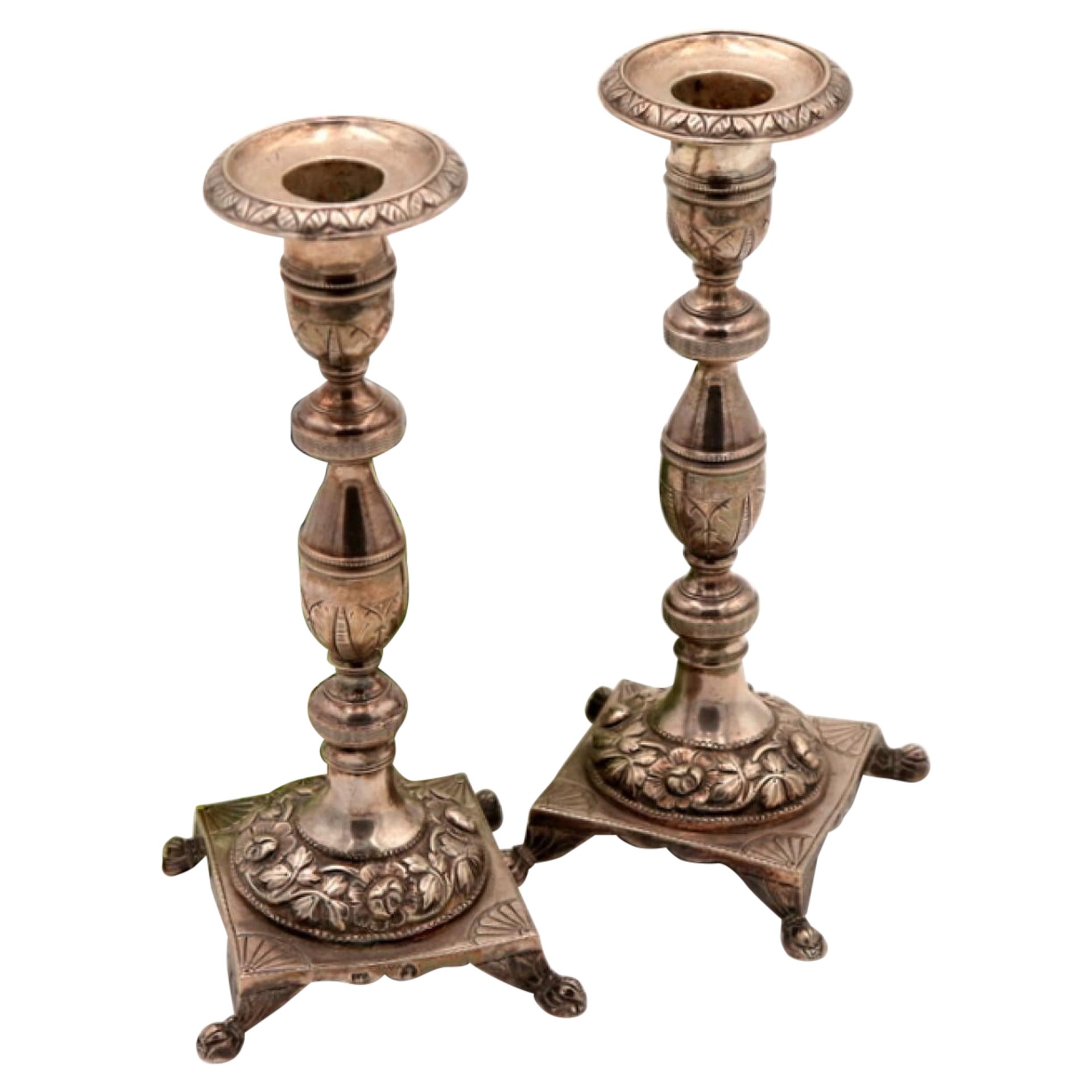 Silver candlesticks with turned shafts on square bases with claw feet