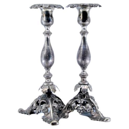Silver candlesticks with turned stems 
acanthus-cut bases