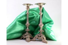 Silver candlesticks with turned stems and acanthus-cut bases